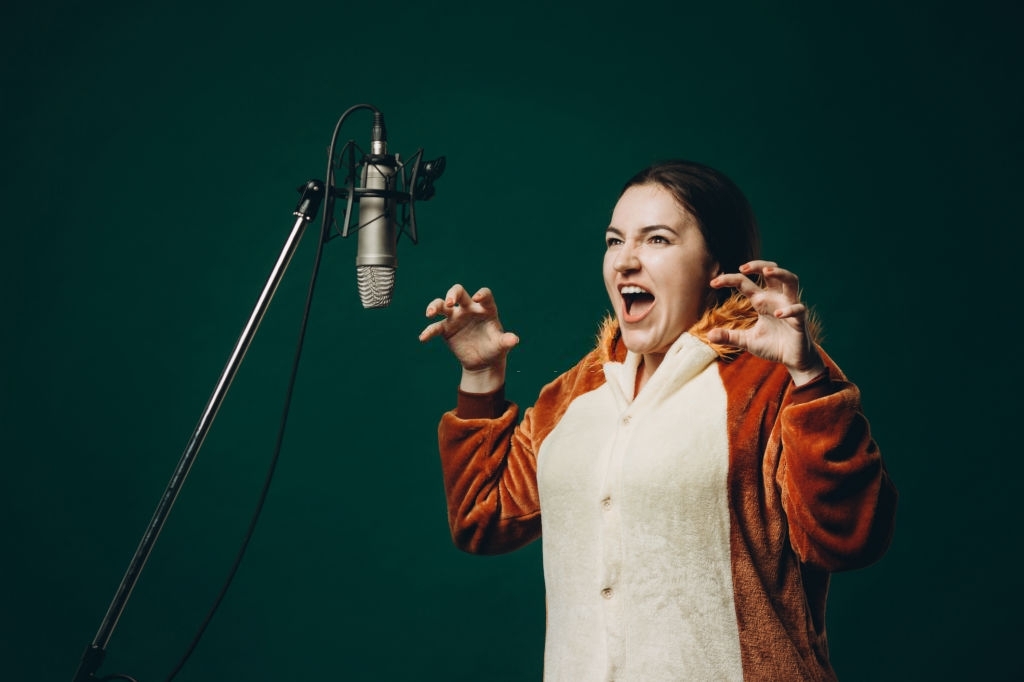 Female voice-over actor recording in a recording or music studio
